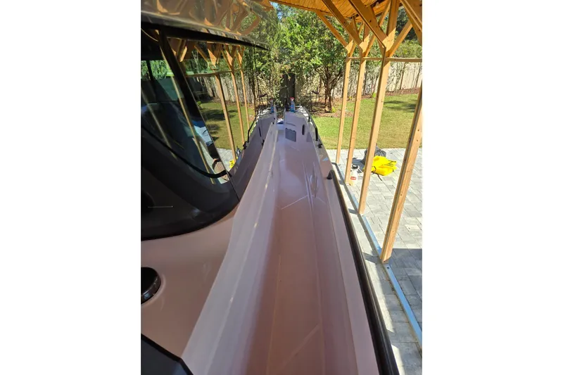 Hell Or High Waters Yacht Photos Pics 2024 Axopar 37XC CROSS CABIN boat under wooden shelter, side view.