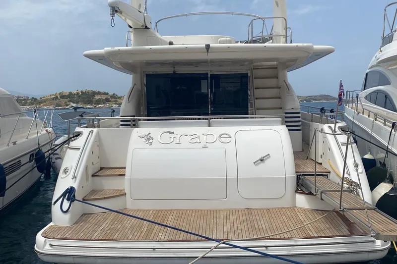 75 Princess 2008 Yacht Photos Pics 2008 Princess 75 Motor Yacht docked, rear view with "Grape" nameplate, wooden deck.