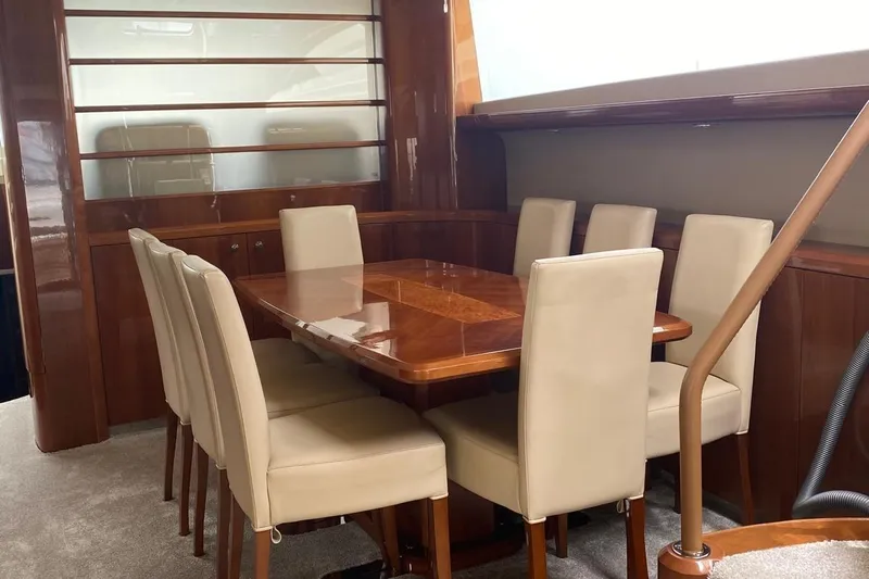 75 Princess 2008 Yacht Photos Pics Luxurious dining area on 2008 Princess 75 Motor Yacht with elegant wood table and chairs.