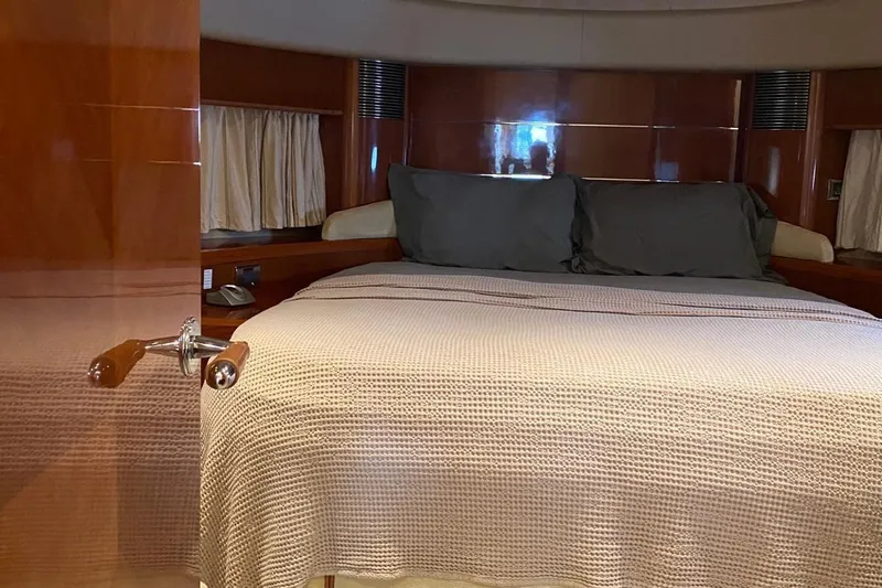 75 Princess 2008 Yacht Photos Pics Luxurious bedroom interior of 2008 Princess 75 Motor Yacht with elegant wood finish.