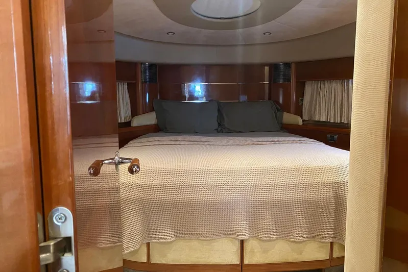 75 Princess 2008 Yacht Photos Pics Luxurious bedroom interior of 2008 Princess 75 Motor Yacht with elegant wood finish.