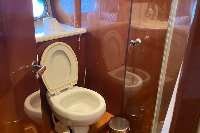 75 Princess 2008 Yacht Photos Pics Luxurious bathroom on 2008 Princess 75 Motor Yacht with wooden finishes and modern amenities.