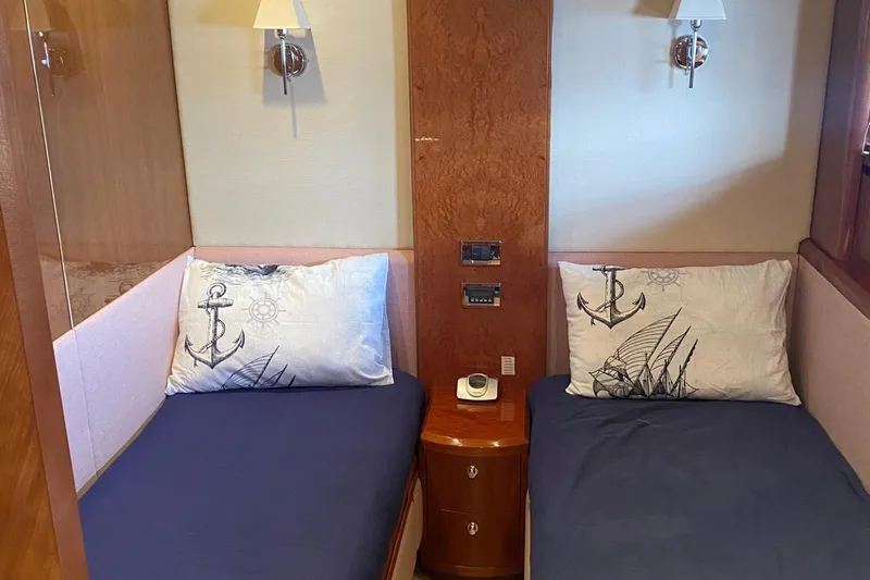 75 Princess 2008 Yacht Photos Pics Twin cabin with nautical-themed pillows on a 2008 Princess 75 Motor Yacht.