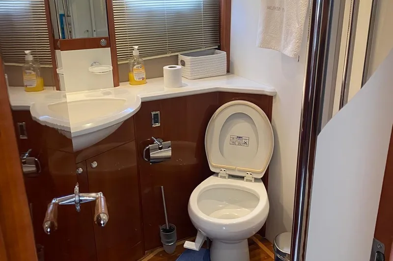 75 Princess 2008 Yacht Photos Pics Luxurious bathroom on 2008 Princess 75 Motor Yacht with modern amenities and wooden accents.