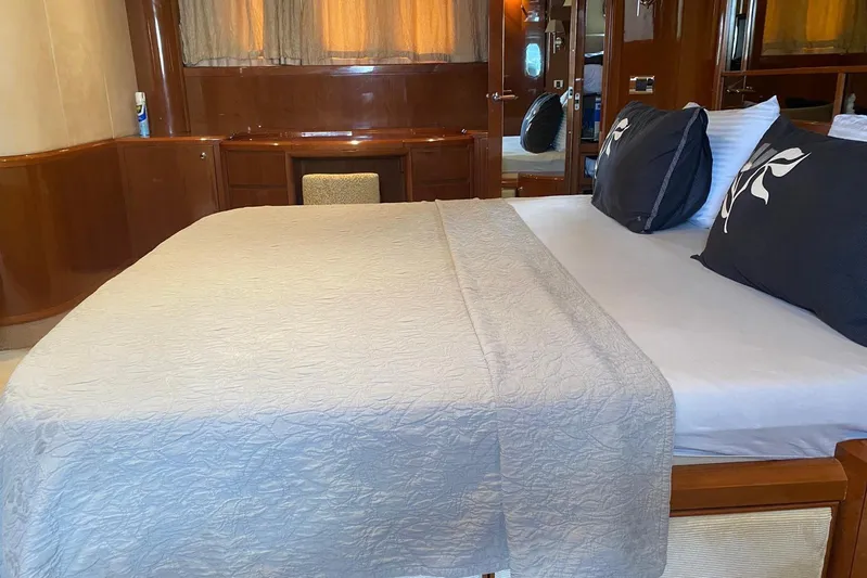 75 Princess 2008 Yacht Photos Pics Luxurious bedroom interior of 2008 Princess 75 Motor Yacht with elegant bedding and wood finishes.