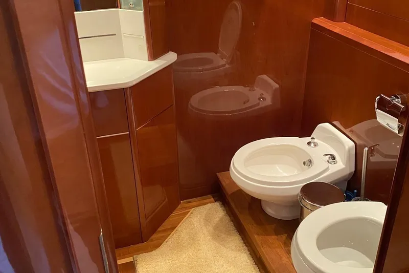 75 Princess 2008 Yacht Photos Pics Luxurious bathroom in 2008 Princess 75 Motor Yacht with wooden cabinetry and modern fixtures.