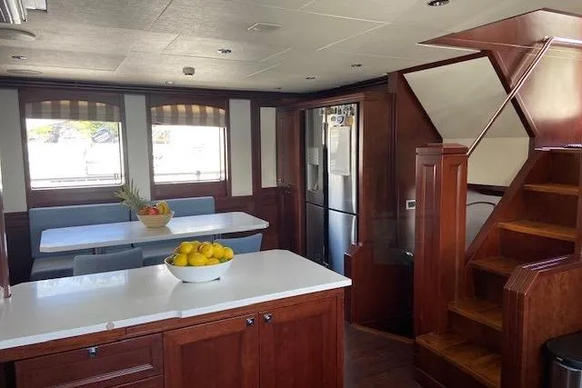 Samsara Yacht Photos Pics Luxurious 2017 Custom Dauntless yacht interior with wooden cabinetry, dining area, and modern kitchen.