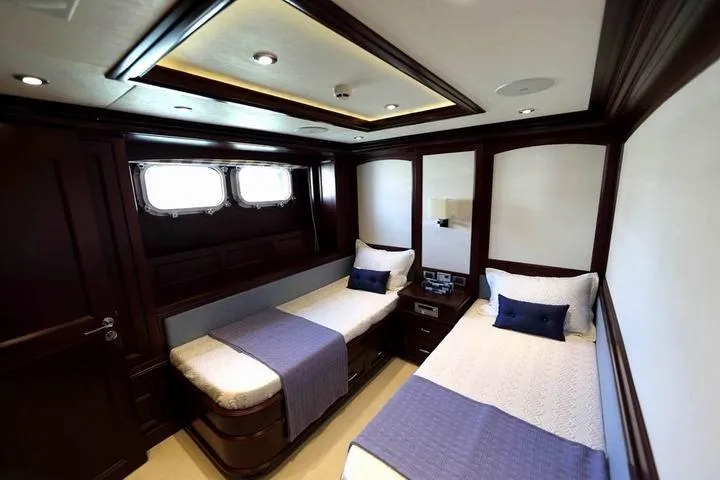 Samsara Yacht Photos Pics Luxurious twin cabin interior on 2017 Custom Dauntless yacht, featuring elegant wood finishes.