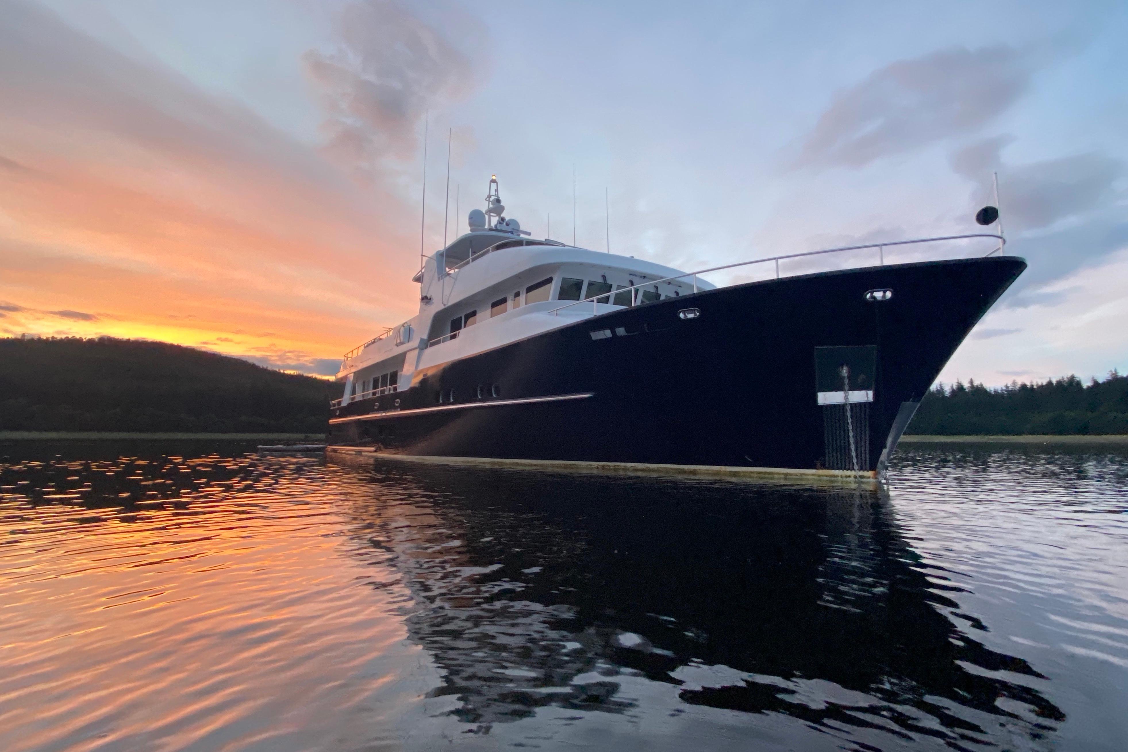 Luxurious 2017 Dauntless Custom yacht at sunset on tranquil waters.
