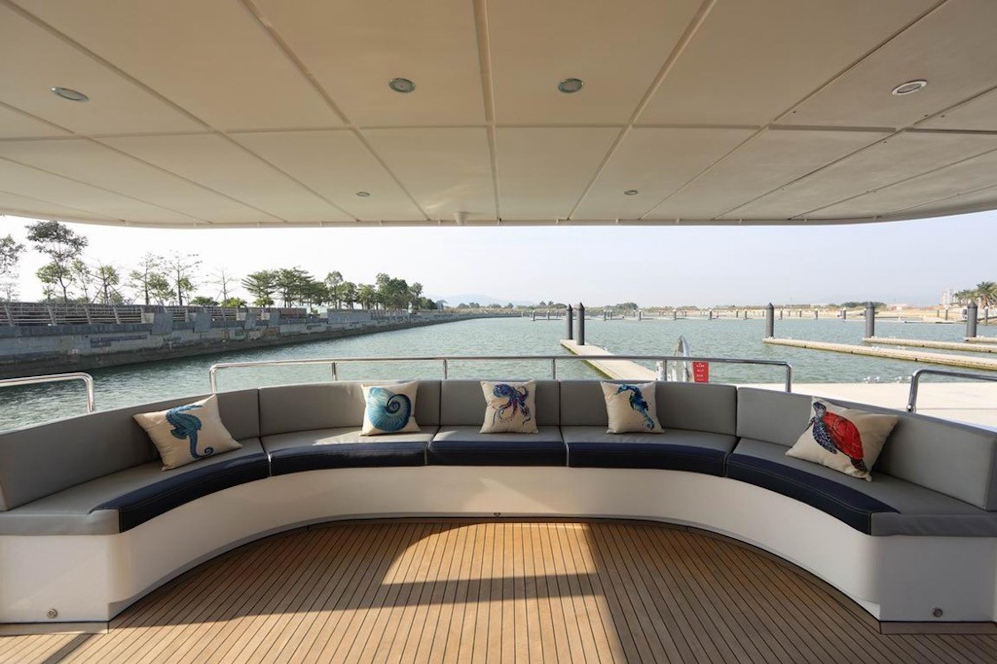 Luxurious 2017 Dauntless Custom yacht deck with curved seating and decorative pillows.
