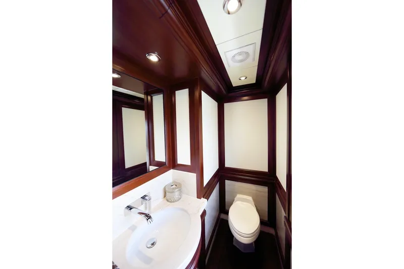 Samsara Yacht Photos Pics Luxurious yacht bathroom with wood accents, featuring a sink and toilet. Custom Dauntless 2017 model.