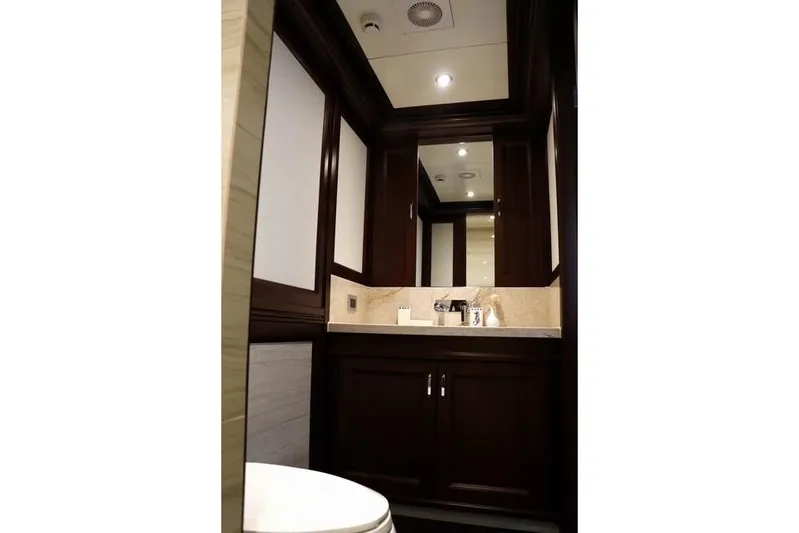 Samsara Yacht Photos Pics Luxurious bathroom interior in 2017 Dauntless Custom yacht, featuring dark wood cabinetry.