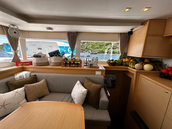 Flotation Therapy Yacht Photos Pics Interior of 2019 Lagoon 450F yacht with cozy seating and fruit display.