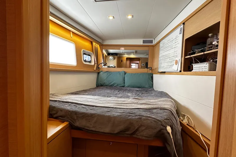Flotation Therapy Yacht Photos Pics Luxurious cabin interior of 2019 Lagoon 450F catamaran with cozy bed and modern amenities.