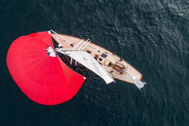 Lady Gwenhyfar Yacht Photos Pics Aerial view of 2018 Spirit Yachts C63 sailing with vibrant red spinnaker.