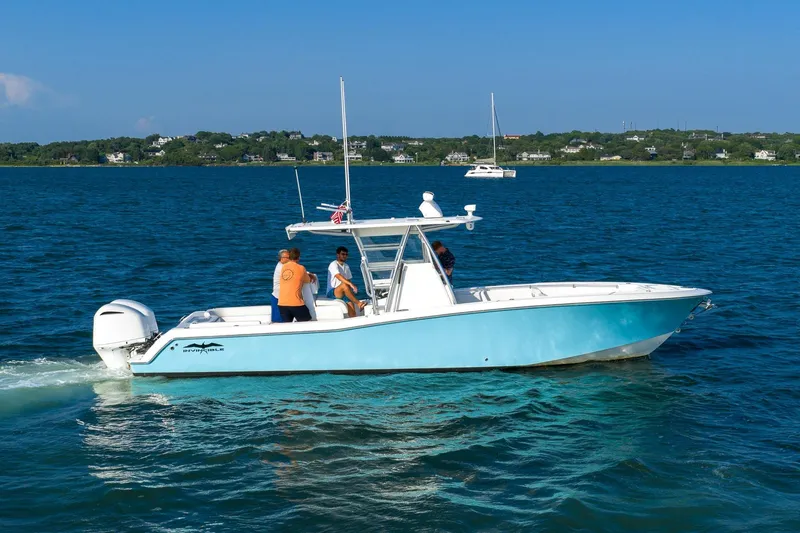 Blue Eyes Yacht Photos Pics 2016 Invincible 33 Open Fisherman boat cruising on blue water with passengers.