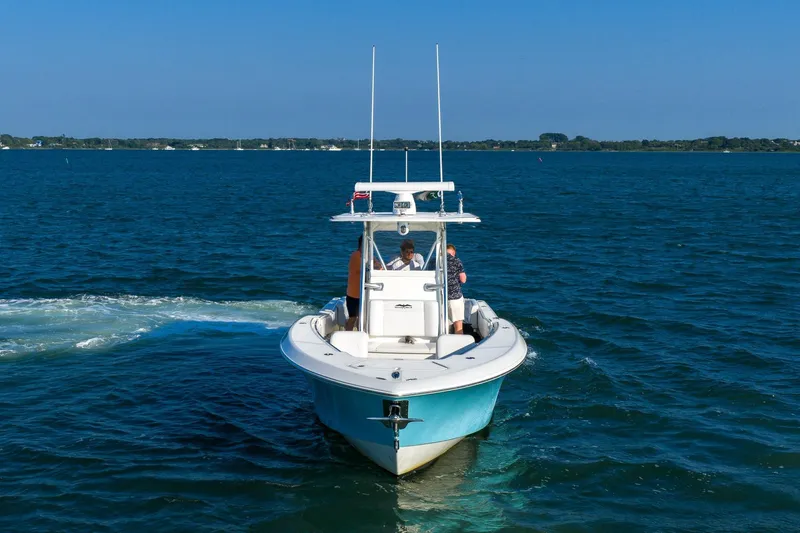 Blue Eyes Yacht Photos Pics 2016 Invincible 33 Open Fisherman boat cruising on a clear blue sea.