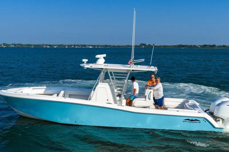 Blue Eyes Yacht Photos Pics 2016 Invincible 33 Open Fisherman boat cruising on blue ocean waters.