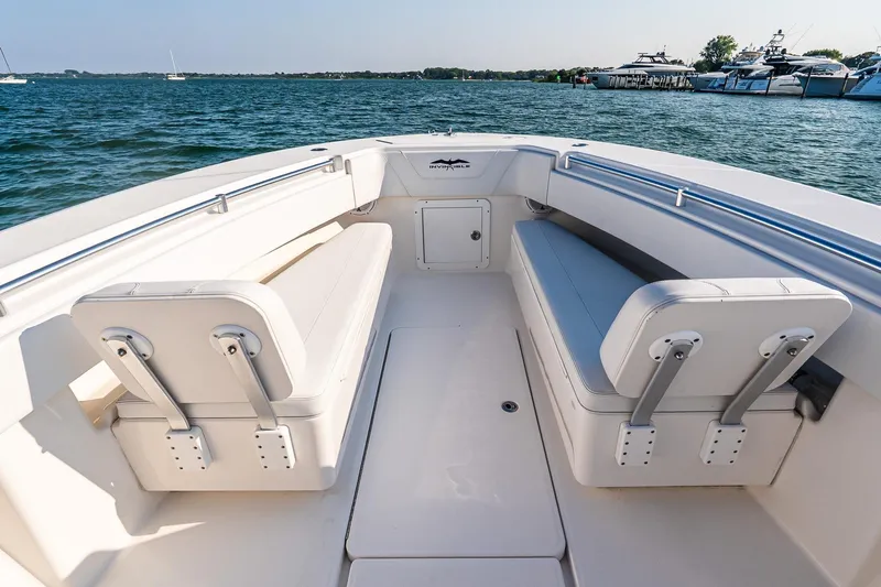 Blue Eyes Yacht Photos Pics 2016 Invincible 33 Open Fisherman boat interior with cushioned seating on calm water.