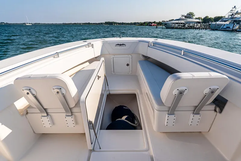 Blue Eyes Yacht Photos Pics 2016 Invincible 33 Open Fisherman boat interior with seating and storage, docked by the water.