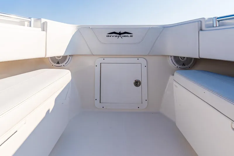 Blue Eyes Yacht Photos Pics 2016 Invincible 33 Open Fisherman boat interior with storage compartment and seating.