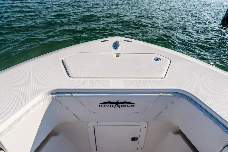 Blue Eyes Yacht Photos Pics Bow of 2016 Invincible 33 Open Fisherman on water, showcasing sleek design.