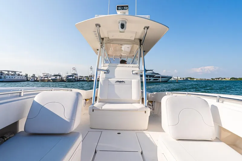 Blue Eyes Yacht Photos Pics 2016 Invincible 33 Open Fisherman boat interior with white seating, docked at marina.