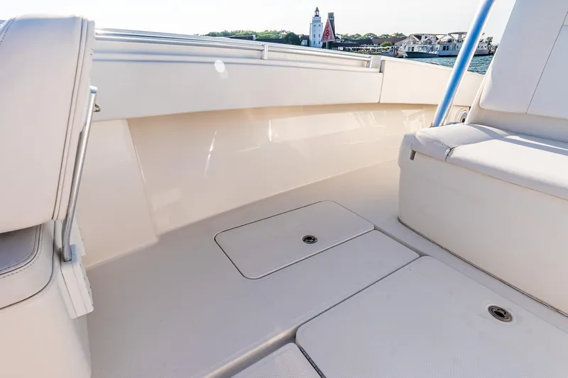 Blue Eyes Yacht Photos Pics 2016 Invincible 33 Open Fisherman boat interior with seating and storage compartments.