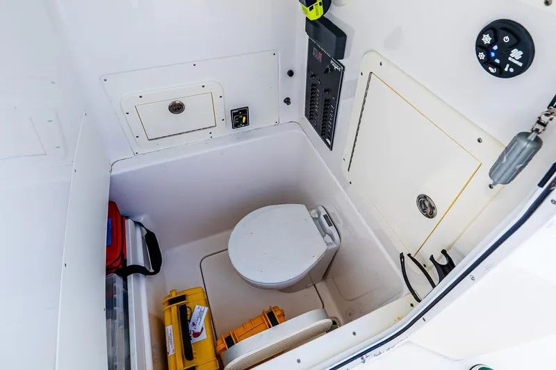 Blue Eyes Yacht Photos Pics Interior of 2016 Invincible 33 Open Fisherman boat with marine toilet and storage compartments.