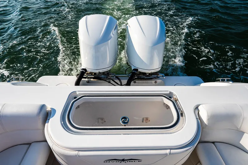 Blue Eyes Yacht Photos Pics 2016 Invincible 33 Open Fisherman boat with dual engines on water.