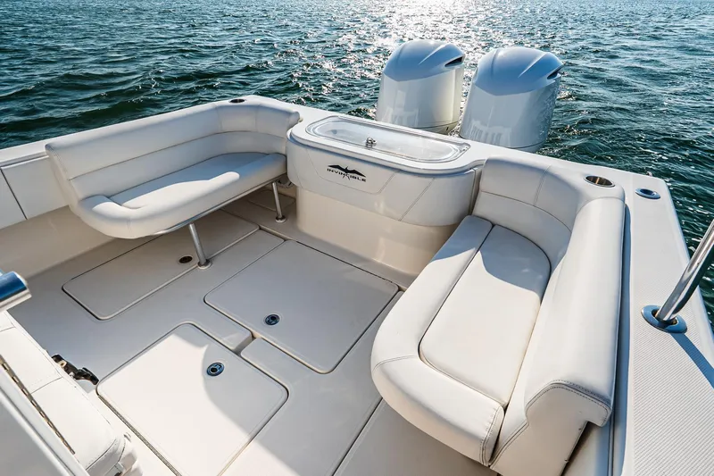 Blue Eyes Yacht Photos Pics 2016 Invincible 33 Open Fisherman boat interior with cushioned seating and twin engines.