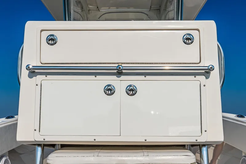 Blue Eyes Yacht Photos Pics 2016 Invincible 33 Open Fisherman boat console with storage compartments and chrome handles.