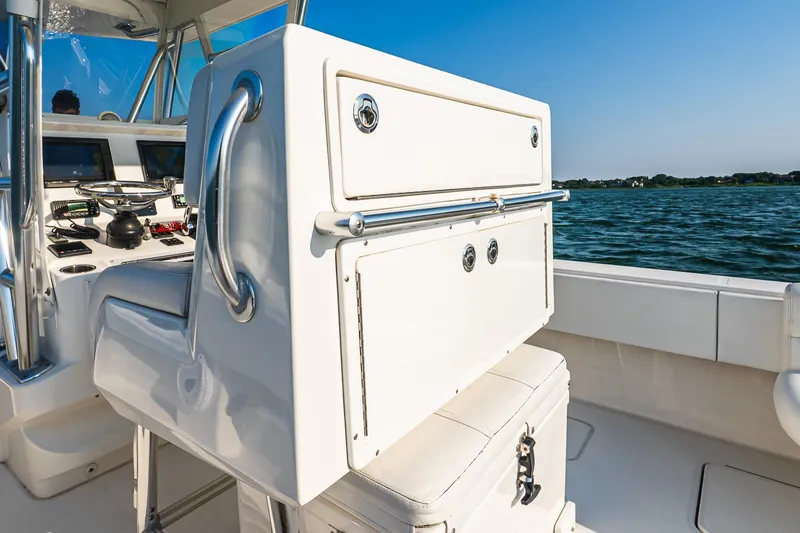 Blue Eyes Yacht Photos Pics 2016 Invincible 33 Open Fisherman boat interior with steering console, on calm water.