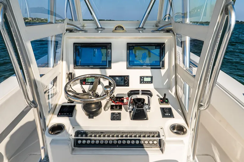Blue Eyes Yacht Photos Pics 2016 Invincible 33 Open Fisherman boat console with dual navigation screens and controls.