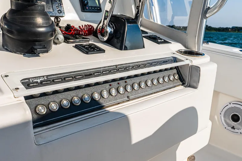Blue Eyes Yacht Photos Pics Control panel of 2016 Invincible 33 Open Fisherman boat with various switches and controls.