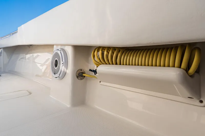 Blue Eyes Yacht Photos Pics 2016 Invincible 33 Open Fisherman boat deck with coiled yellow hose and speaker.