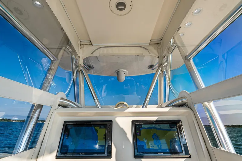 Blue Eyes Yacht Photos Pics Interior view of 2016 Invincible 33 Open Fisherman boat with navigation screens.
