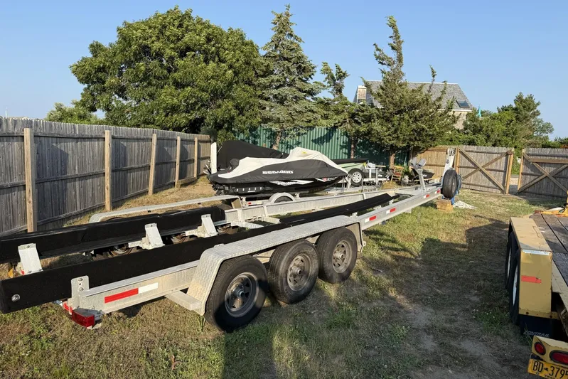Blue Eyes Yacht Photos Pics Trailer for 2016 Invincible 33 Open Fisherman boat parked in a yard.