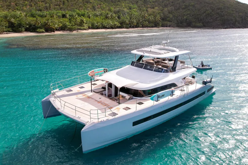 Cest La Vie Yacht Photos Pics 2022 Lagoon SIXTY 7 yacht cruising in turquoise waters near a tropical island.