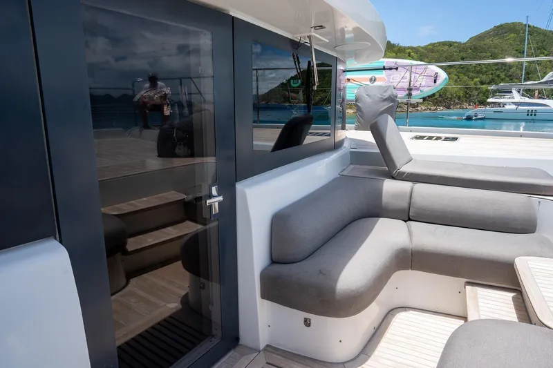 Cest La Vie Yacht Photos Pics Luxurious 2022 Lagoon SIXTY 7 yacht with sleek seating and scenic ocean view.