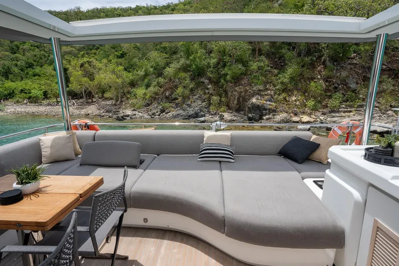 Cest La Vie Yacht Photos Pics Luxurious 2022 Lagoon SIXTY 7 yacht interior with plush seating and scenic ocean view.