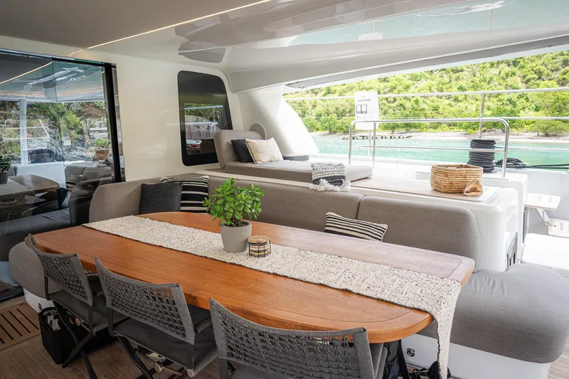 Cest La Vie Yacht Photos Pics Luxurious Lagoon SIXTY 7 yacht interior, featuring elegant dining area with scenic ocean view, 2022 model.