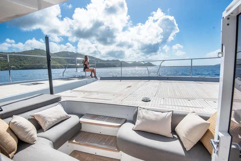 Cest La Vie Yacht Photos Pics Luxurious 2022 Lagoon SIXTY 7 yacht deck with scenic ocean view and comfortable seating.