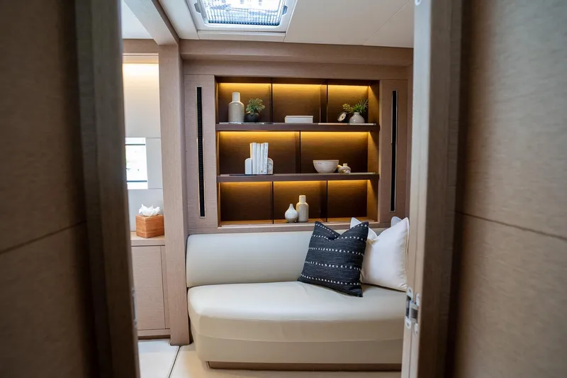 Cest La Vie Yacht Photos Pics Luxurious interior of 2022 Lagoon SIXTY 7 yacht with elegant seating and decorative shelving.