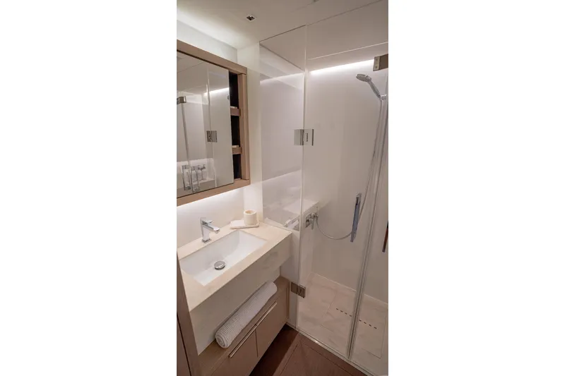 Cest La Vie Yacht Photos Pics Luxurious bathroom in 2022 Lagoon SIXTY 7 yacht with modern fixtures and elegant design.