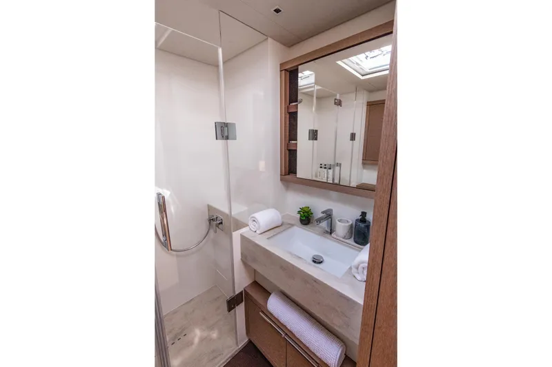 Cest La Vie Yacht Photos Pics Luxurious bathroom in 2022 Lagoon SIXTY 7 yacht with modern fixtures and elegant design.