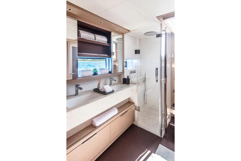 Cest La Vie Yacht Photos Pics Luxurious bathroom in 2022 Lagoon SIXTY 7 yacht, featuring modern fixtures and elegant design.