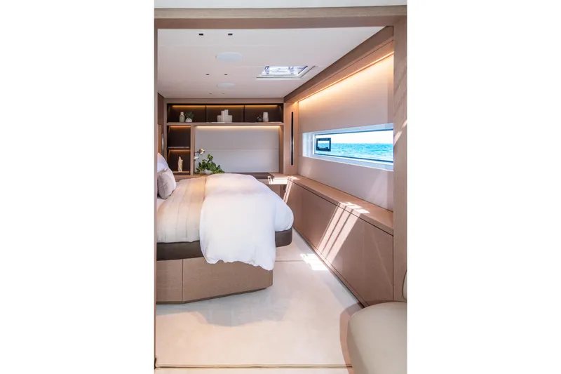 Cest La Vie Yacht Photos Pics Luxurious bedroom interior of 2022 Lagoon SIXTY 7 yacht with ocean view window.