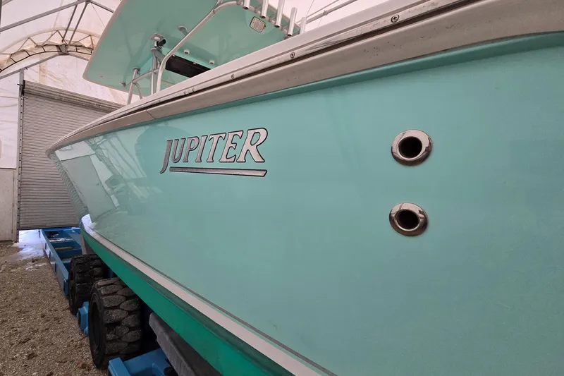  Yacht Photos Pics 2010 Jupiter 34 FS boat in storage, showcasing sleek turquoise hull design.