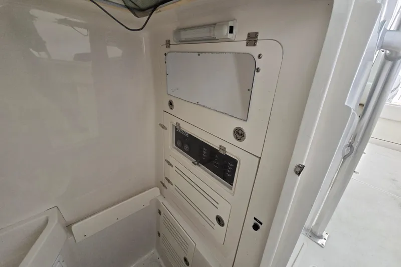  Yacht Photos Pics Control panel inside a 2010 Jupiter 34 FS boat, featuring various switches and compartments.